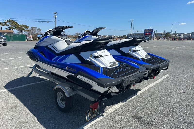 Slide: The Image of 2023 Yamaha WaveRunner FX SHO jet skis on a trailer in a parking lot. - 4