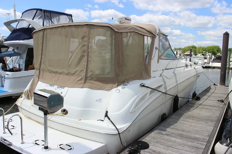 The Image of 2001 Sea Ray 380 Sundancer yacht docked at marina under blue sky. - 1
