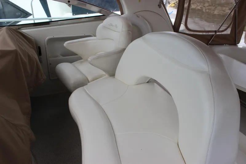 Slide: The Image of Interior seating of 2001 Sea Ray 380 Sundancer, featuring white leather upholstery. - 10