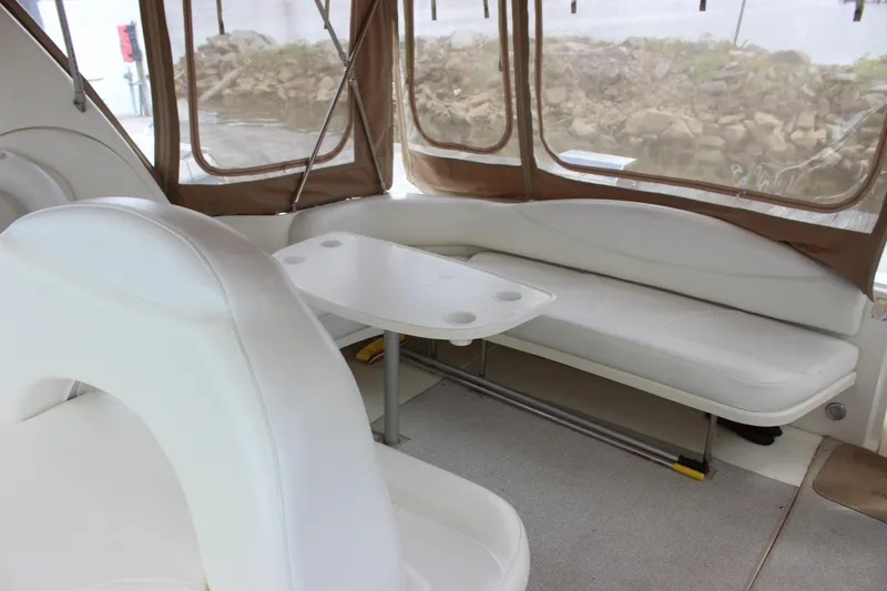 Slide: The Image of Interior of 2001 Sea Ray 380 Sundancer with white seating and table. - 12