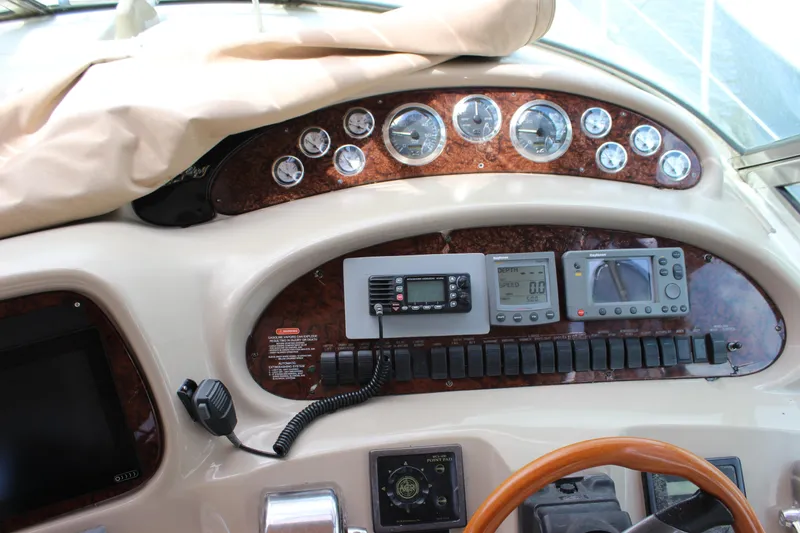 Slide: The Image of Control panel of a 2001 Sea Ray 380 Sundancer boat with gauges and navigation equipment. - 13