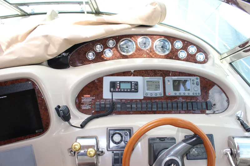 Slide: The Image of 2001 Sea Ray 380 Sundancer helm with gauges, controls, and steering wheel. - 14