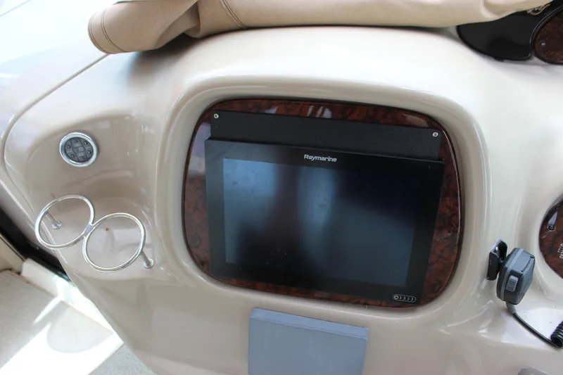 Slide: The Image of Dashboard of 2001 Sea Ray 380 Sundancer with Raymarine display and cup holders. - 15