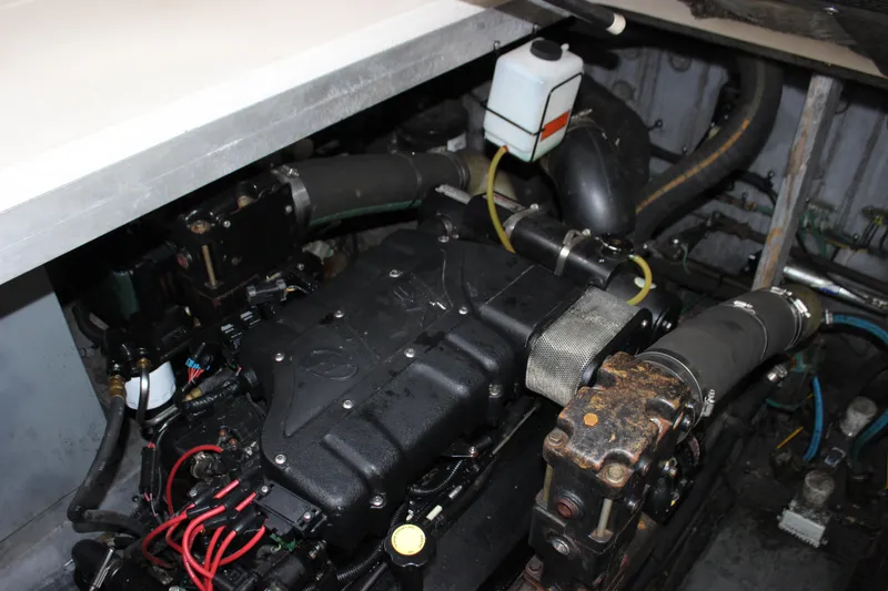 Slide: The Image of Engine compartment of a 2001 Sea Ray 380 Sundancer boat, showcasing mechanical components. - 16