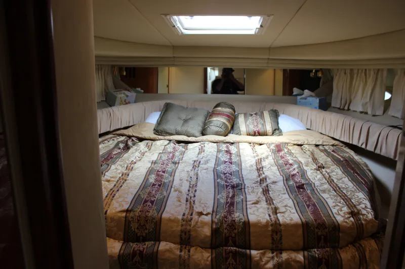 Slide: The Image of Luxurious cabin interior of 2001 Sea Ray 380 Sundancer with elegant bedding and cushions. - 21