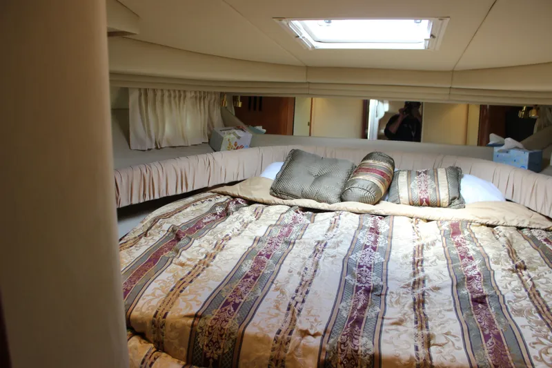 Slide: The Image of Luxurious cabin interior of 2001 Sea Ray 380 Sundancer with elegant bedding and cushions. - 22
