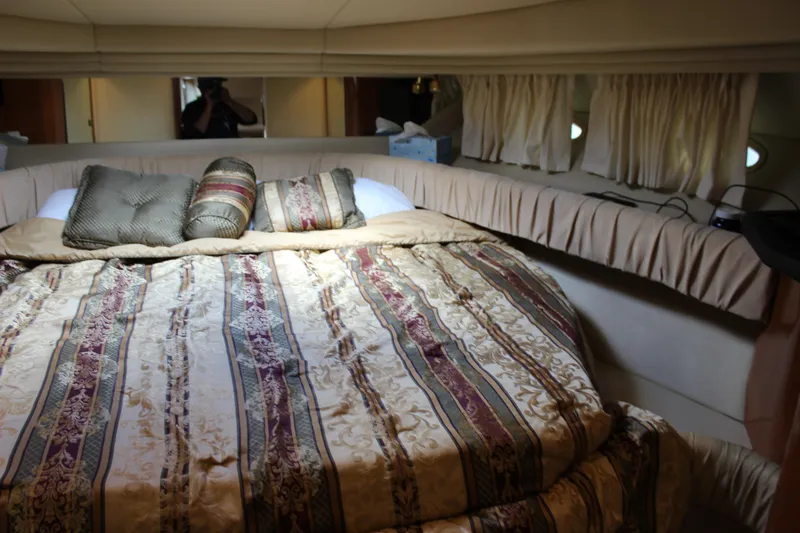 Slide: The Image of Luxurious cabin interior of 2001 Sea Ray 380 Sundancer with elegant bedding and cushions. - 23