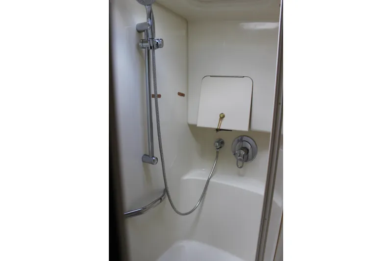 Slide: The Image of Shower area in 2001 Sea Ray 380 Sundancer yacht, featuring handheld showerhead and controls. - 26