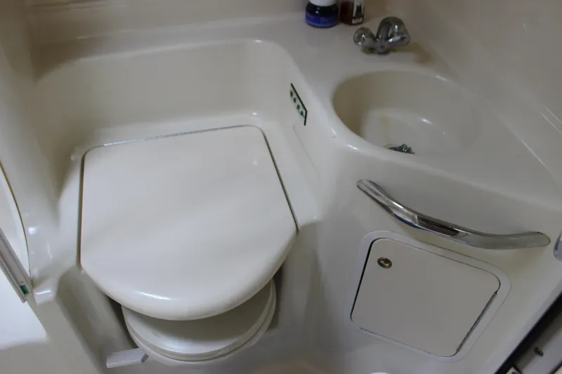 Slide: The Image of 2001 Sea Ray 380 Sundancer bathroom with compact toilet and sink. - 27