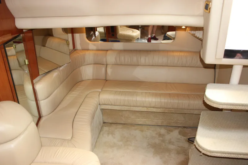 Slide: The Image of Interior of 2001 Sea Ray 380 Sundancer with beige leather seating and mirrored accents. - 28
