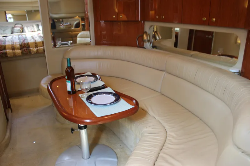 Slide: The Image of Luxurious interior of 2001 Sea Ray 380 Sundancer yacht with dining setup. - 29