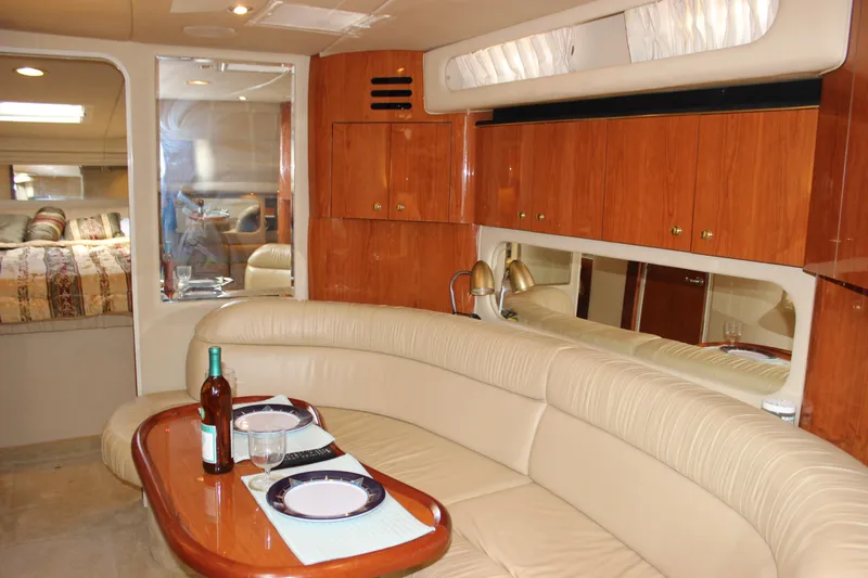 Slide: The Image of Luxurious interior of 2001 Sea Ray 380 Sundancer yacht with dining area and wood cabinetry. - 30