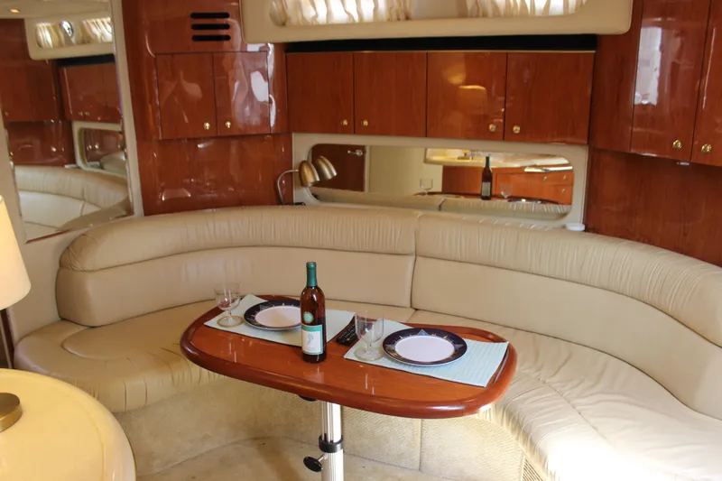 Slide: The Image of Luxurious interior of a 2001 Sea Ray 380 Sundancer yacht with elegant dining setup. - 34