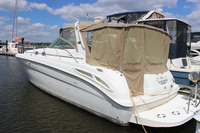 Slide: The Image of 2001 Sea Ray 380 Sundancer yacht docked at marina under blue sky. - 5