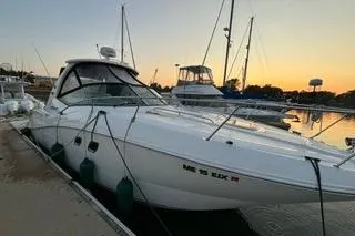 The Image of 2007 Sea Ray Sundancer 310 docked at sunset, showcasing sleek design and luxury features. - 0