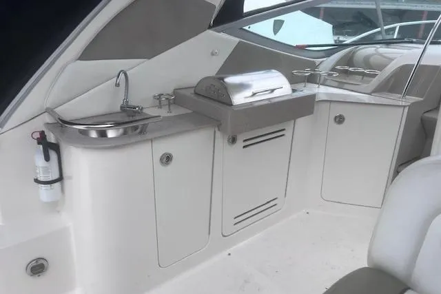 Slide: The Image of 2007 Sea Ray Sundancer 310 yacht interior with kitchenette and grill setup. - 11