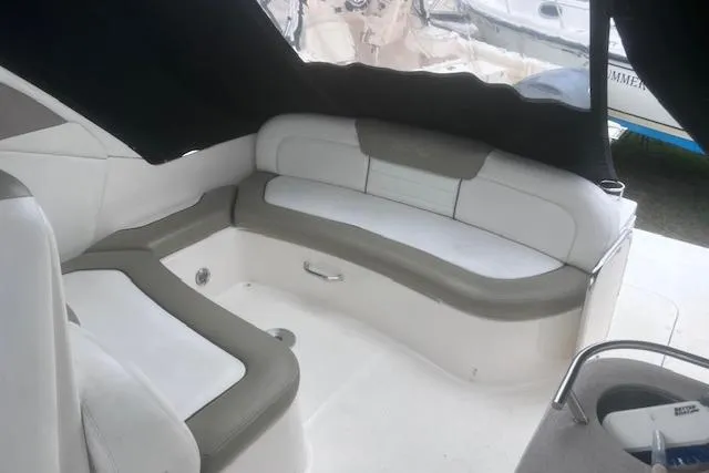 Slide: The Image of 2007 Sea Ray Sundancer 310 interior with cushioned seating and sleek design. - 12