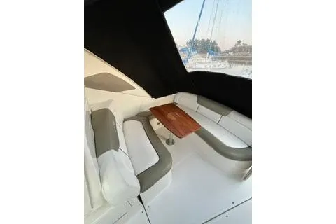 Slide: The Image of 2007 Sea Ray Sundancer 310 interior with seating and wooden table. - 13