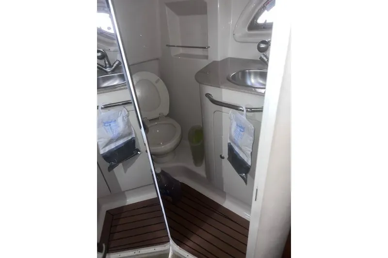 Slide: The Image of Bathroom interior of 2007 Sea Ray Sundancer 310 yacht, featuring toilet and sink. - 24