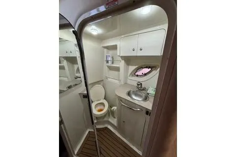 Slide: The Image of 2007 Sea Ray Sundancer 310 bathroom with sink, toilet, and storage cabinets. - 25
