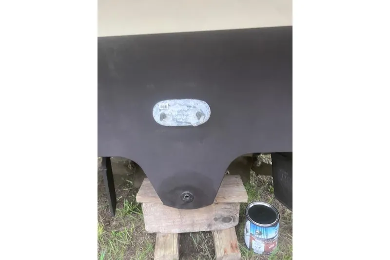 Slide: The Image of 2007 Sea Ray Sundancer 310 hull with paint can, resting on wooden blocks. - 27