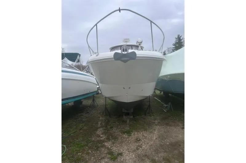 Slide: The Image of 2007 Sea Ray Sundancer 310 boat on land, front view, overcast sky. - 4