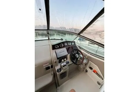 Slide: The Image of 2007 Sea Ray Sundancer 310 cockpit with steering wheel and control panel. - 8