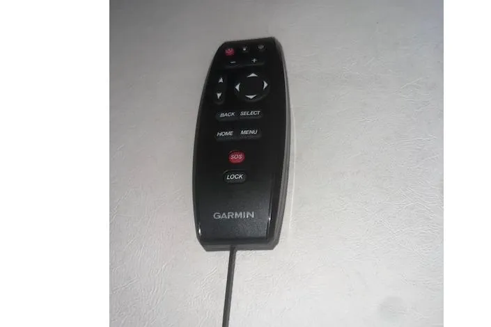 Slide: The Image of Garmin remote control for 2007 Sea Ray Sundancer 310, featuring navigation and SOS buttons. - 9