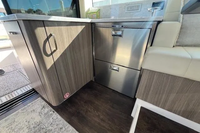 Slide: The Image of Interior of 2022 Regal 38 XO yacht featuring modern cabinetry and stainless steel appliances. - 6