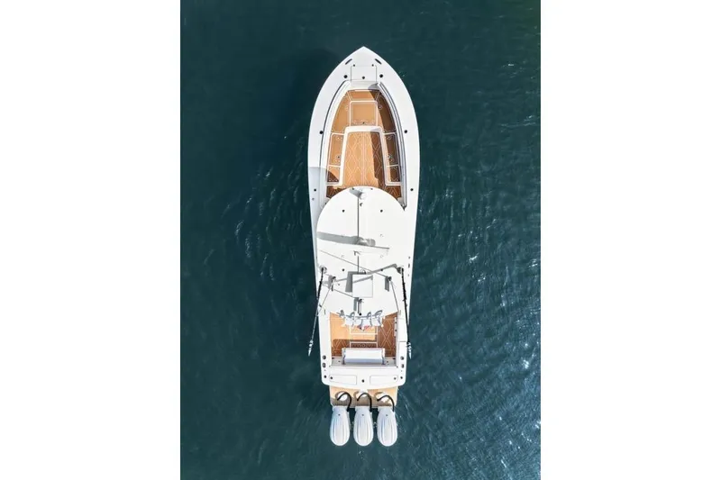 Slide: The Image of Aerial view of 2024 Regulator 34 boat on water, showcasing sleek design and twin engines. - 4