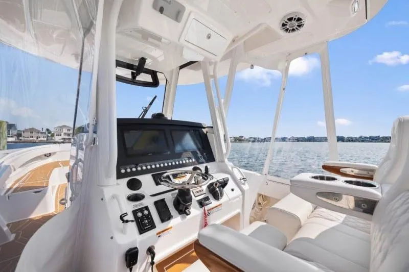 Slide: The Image of 2024 Regulator 34 boat cockpit with advanced navigation system and luxurious seating. - 7