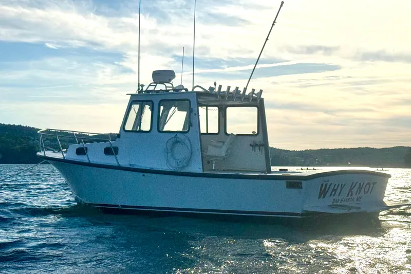 Slide: The Image of 2001 Eastern 27 Lobster Fisherman boat on water at sunset, named "Why Knot". - 21