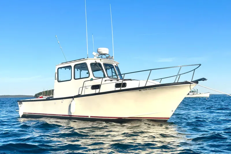 Slide: The Image of 2001 Eastern 27 Lobster Fisherman boat on calm blue water under clear sky. - 22
