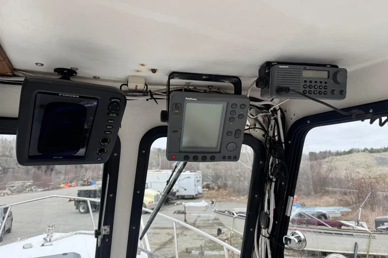 Slide: The Image of Boat cockpit with navigation equipment, featuring Furuno and Raytheon displays, Eastern Lobsterman 27, 2001. - 7