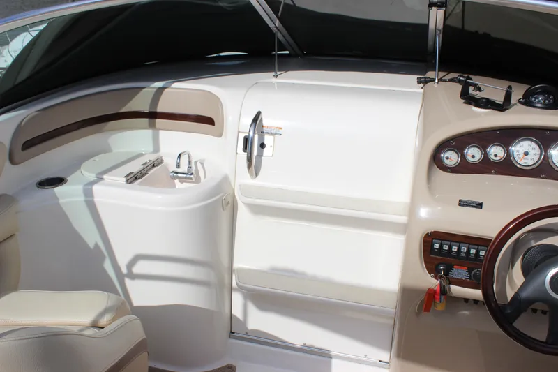 Slide: The Image of 2005 Chaparral 265 SSi boat interior with steering wheel and dashboard controls. - 10