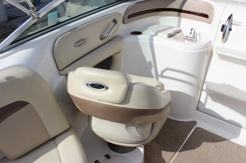 Slide: The Image of 2005 Chaparral 265 SSi boat interior with beige seating and steering area. - 11
