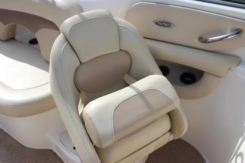 Slide: The Image of 2005 Chaparral 265 SSi boat interior with beige seating and stainless steel accents. - 12