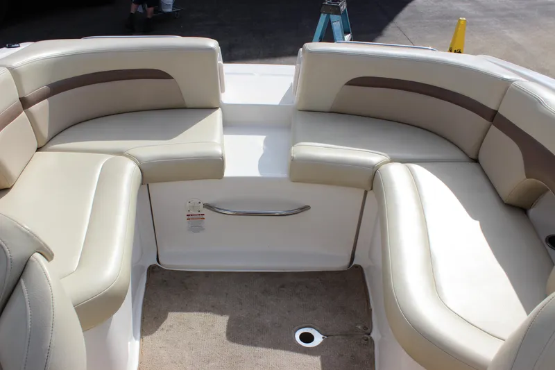 Slide: The Image of 2005 Chaparral 265 SSi boat interior with beige seating and carpeted floor. - 13