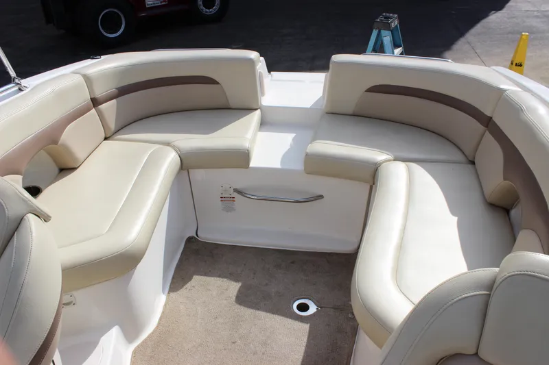 Slide: The Image of 2005 Chaparral 265 SSi boat interior with beige seating and carpeted floor. - 14