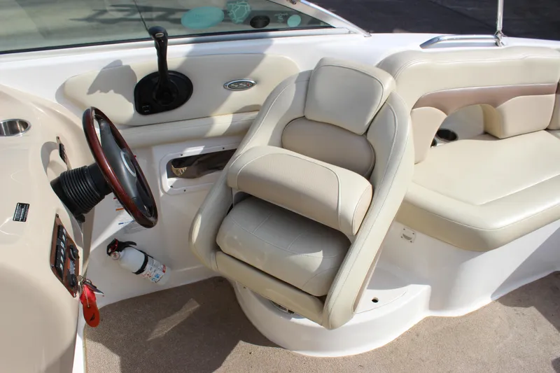 Slide: The Image of Interior of a 2005 Chaparral 265 SSi boat featuring steering wheel and seating. - 15