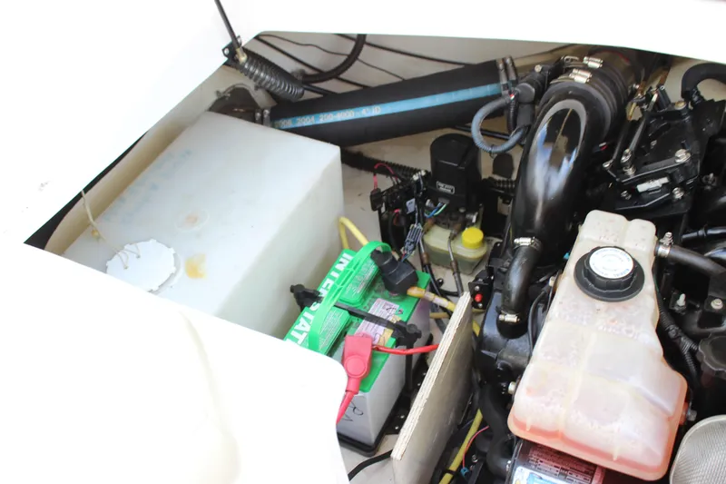 Slide: The Image of Engine compartment of a 2005 Chaparral 265 SSi boat, featuring battery and fluid reservoirs. - 17