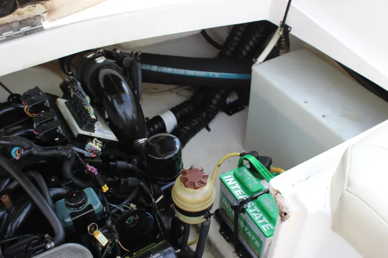 Slide: The Image of Engine compartment of a 2005 Chaparral 265 SSi boat with visible battery and components. - 18