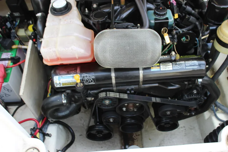 Slide: The Image of Engine compartment of a 2005 Chaparral 265 SSi boat, showcasing mechanical components. - 19
