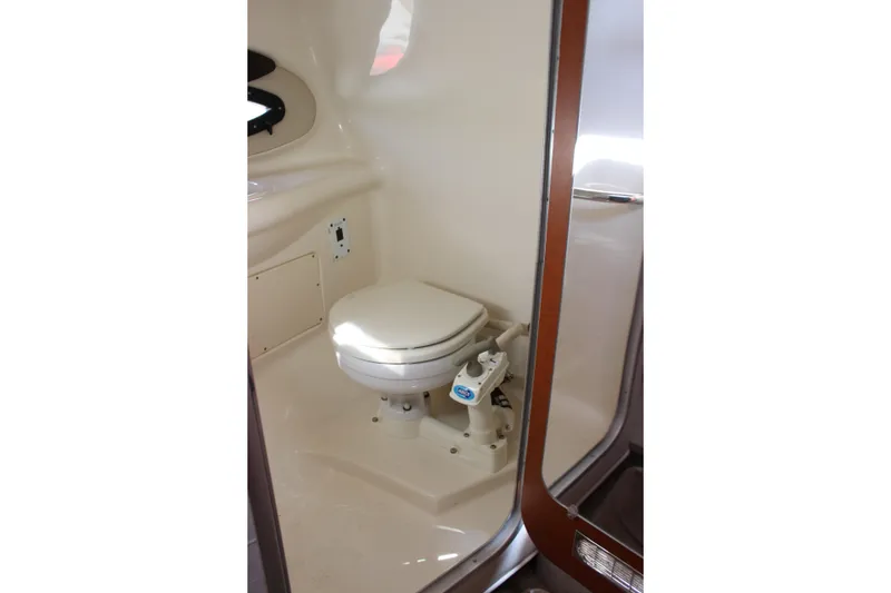 Slide: The Image of 2005 Chaparral 265 SSi boat interior with compact marine toilet. - 25