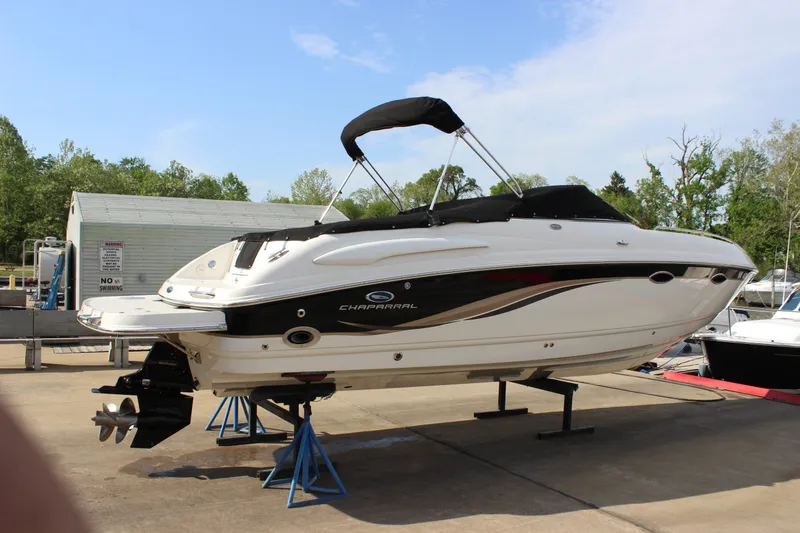 Slide: The Image of 2005 Chaparral 265 SSi boat on stands, outdoor setting, clear sky. - 29