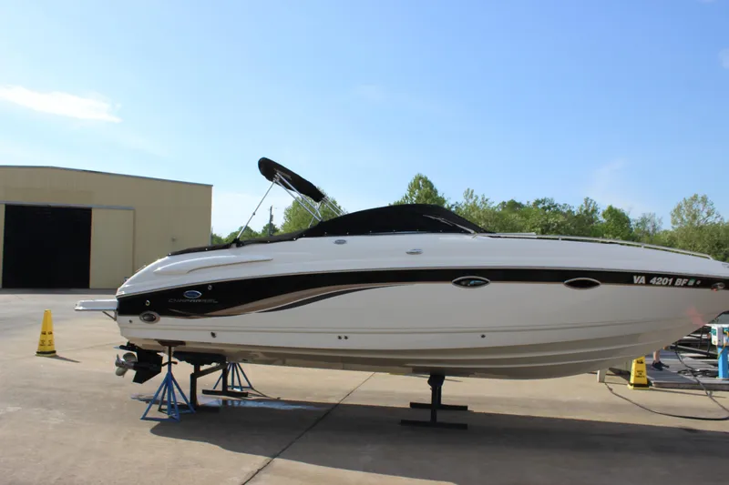 Slide: The Image of 2005 Chaparral 265 SSi boat on stands, outdoors, with clear sky background. - 30