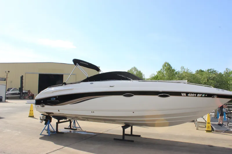 Slide: The Image of 2005 Chaparral 265 SSi boat on stands, outdoor setting, clear sky. - 31