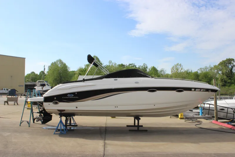 Slide: The Image of 2005 Chaparral 265 SSi boat on stands, outdoor setting, clear sky background. - 6