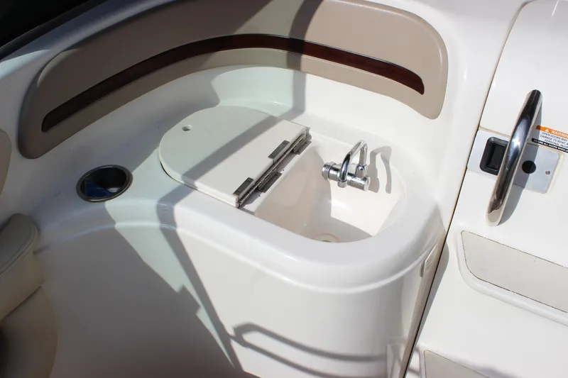 Slide: The Image of 2005 Chaparral 265 SSi boat interior with sink and cup holder. - 8