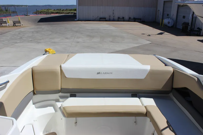 Slide: The Image of 2005 Larson LXi 268 boat interior with beige seating at a marina. - 6